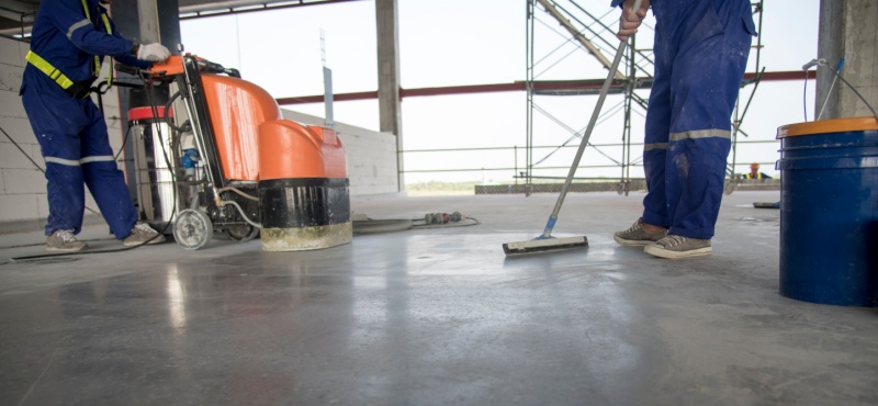 Crew using a floor machine during construction site cleaning services in Pompano Beach