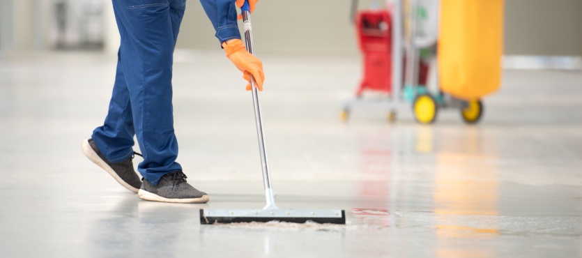 Dust mopping a commercial floor during commercial cleaning in Pompano Beach