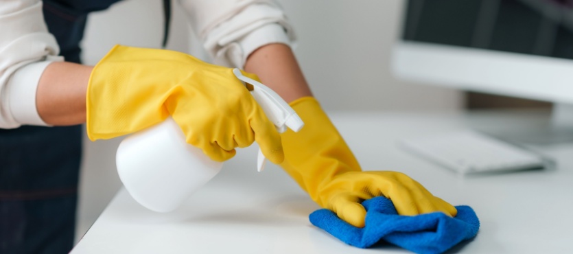 Spraying and wiping a surface during restaurant commercial cleaning in Pompano Beach