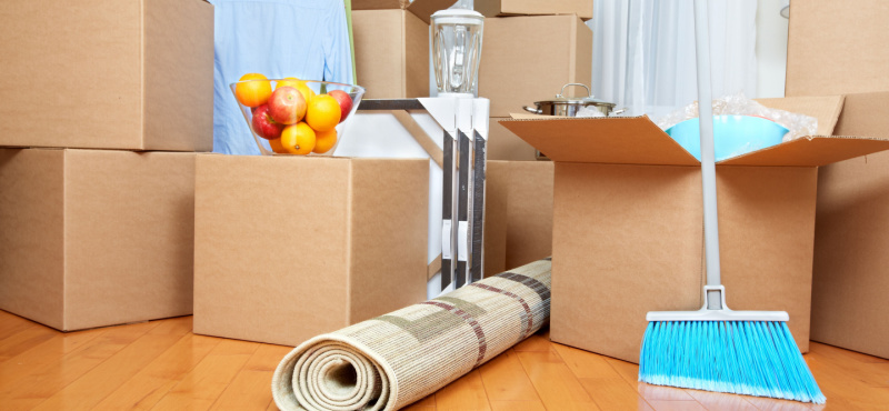 Moving boxes and a broom ready for move out cleaning in Davie