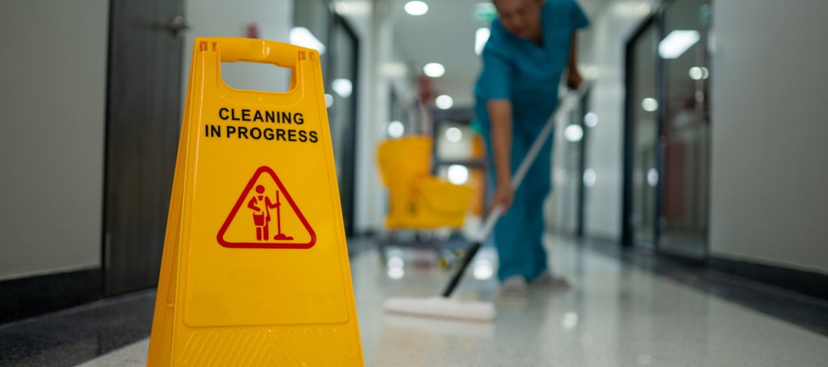 Wet floor sign in a hallway after a leak, handled by janitorial services in Davie