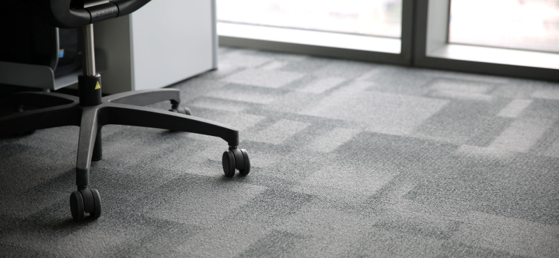 Clean office carpet under a desk chair after commercial cleaning in Fort Lauderdale
