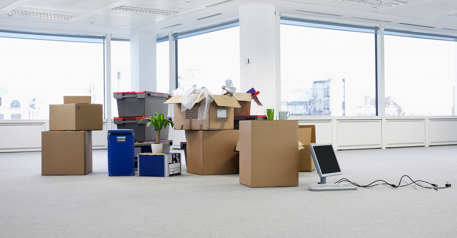 Moving boxes in an empty office before move out cleaning in Pompano Beach