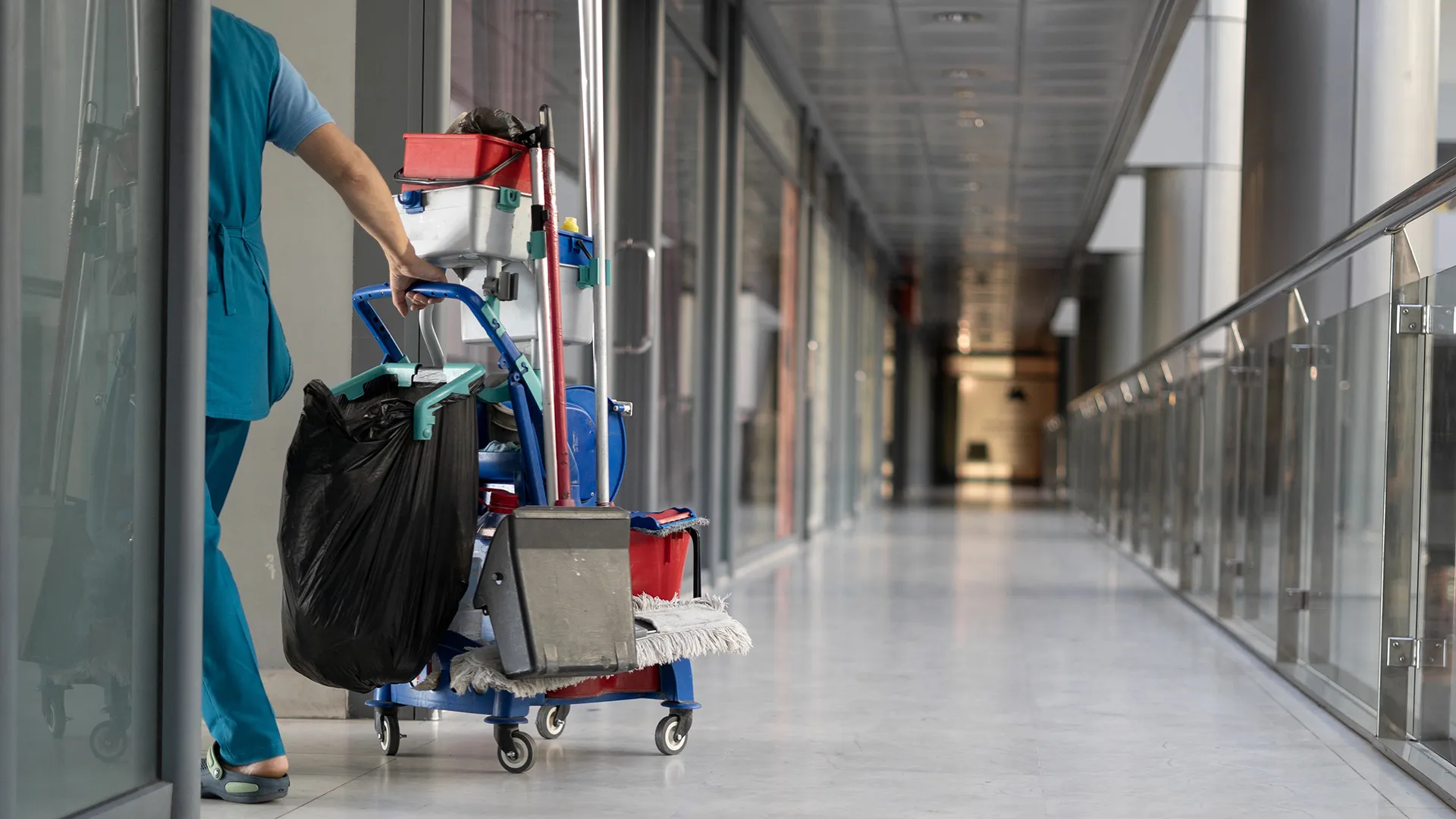 Janitorial cart in a clean building hallway for janitorial services in Coral Springs