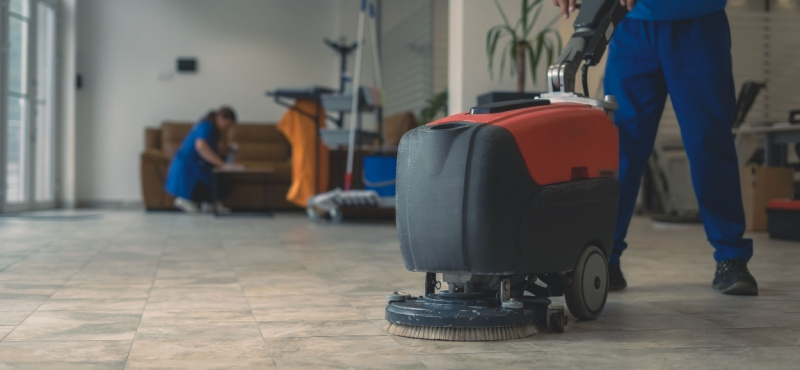 Floor scrubber cleaning a retail floor during commercial floor cleaning in Plantation