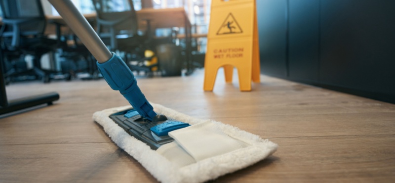 Microfiber mop on a wood floor during commercial floor cleaning in Delray Beach