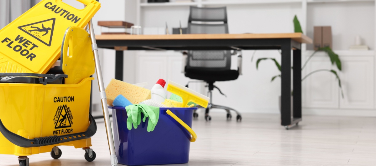 Cleaning cart and wet floor sign in an office during commercial cleaning in Plantation