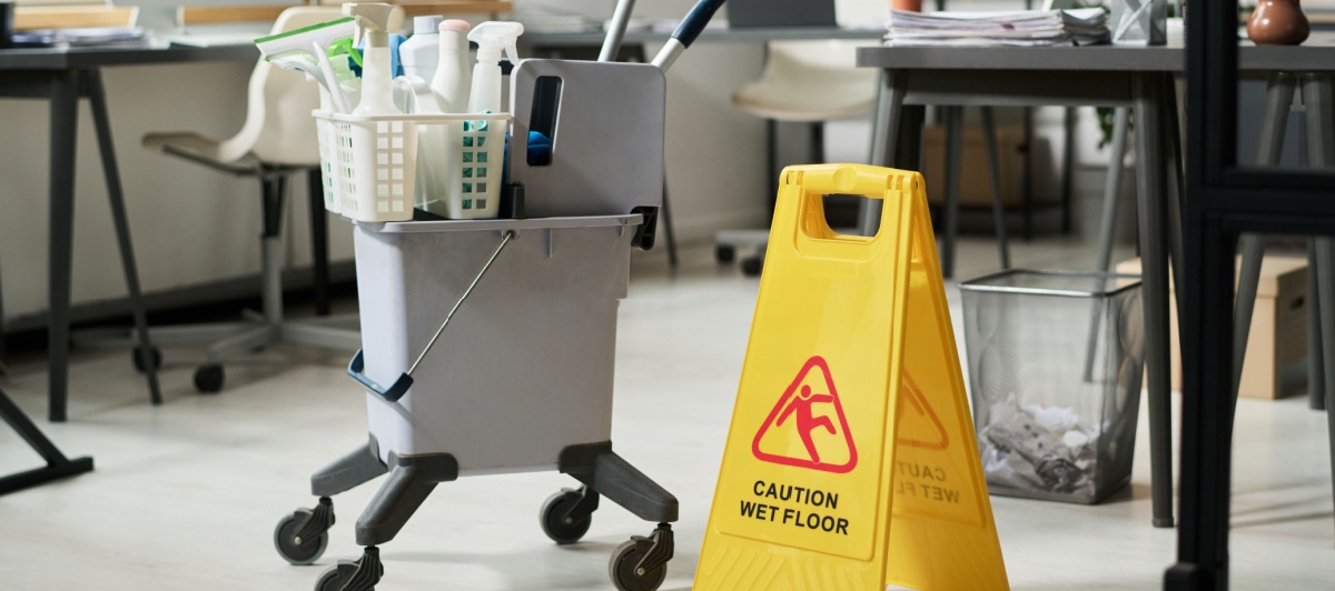 Office cleaning company cart and wet floor sign in a Pompano Beach office
