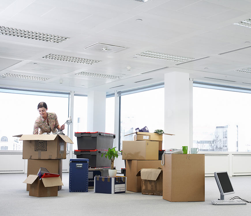 Man packing boxes in an office before move out cleaning in Coral Springs