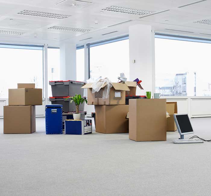 Moving boxes in an empty office ready for move out cleaning in Pompano Beach