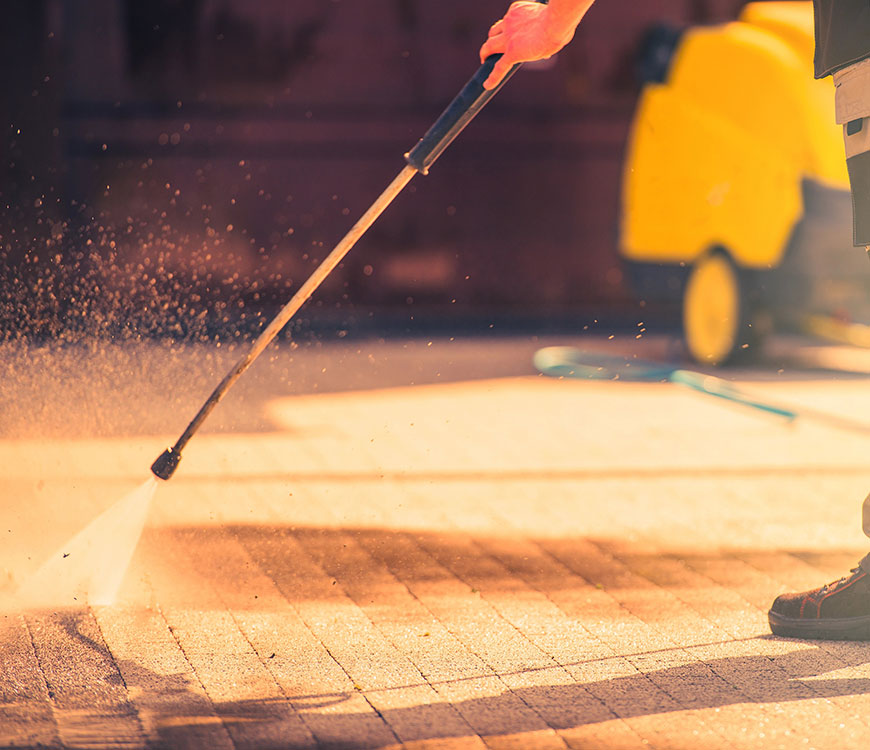 A brick walkway undergoing commercial pressure cleaning in Delray Beach, FL